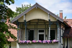 Ornate balcony with flowers and traditional architecture.