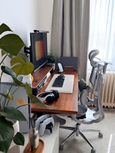 A modern desk setup with a computer and chair.