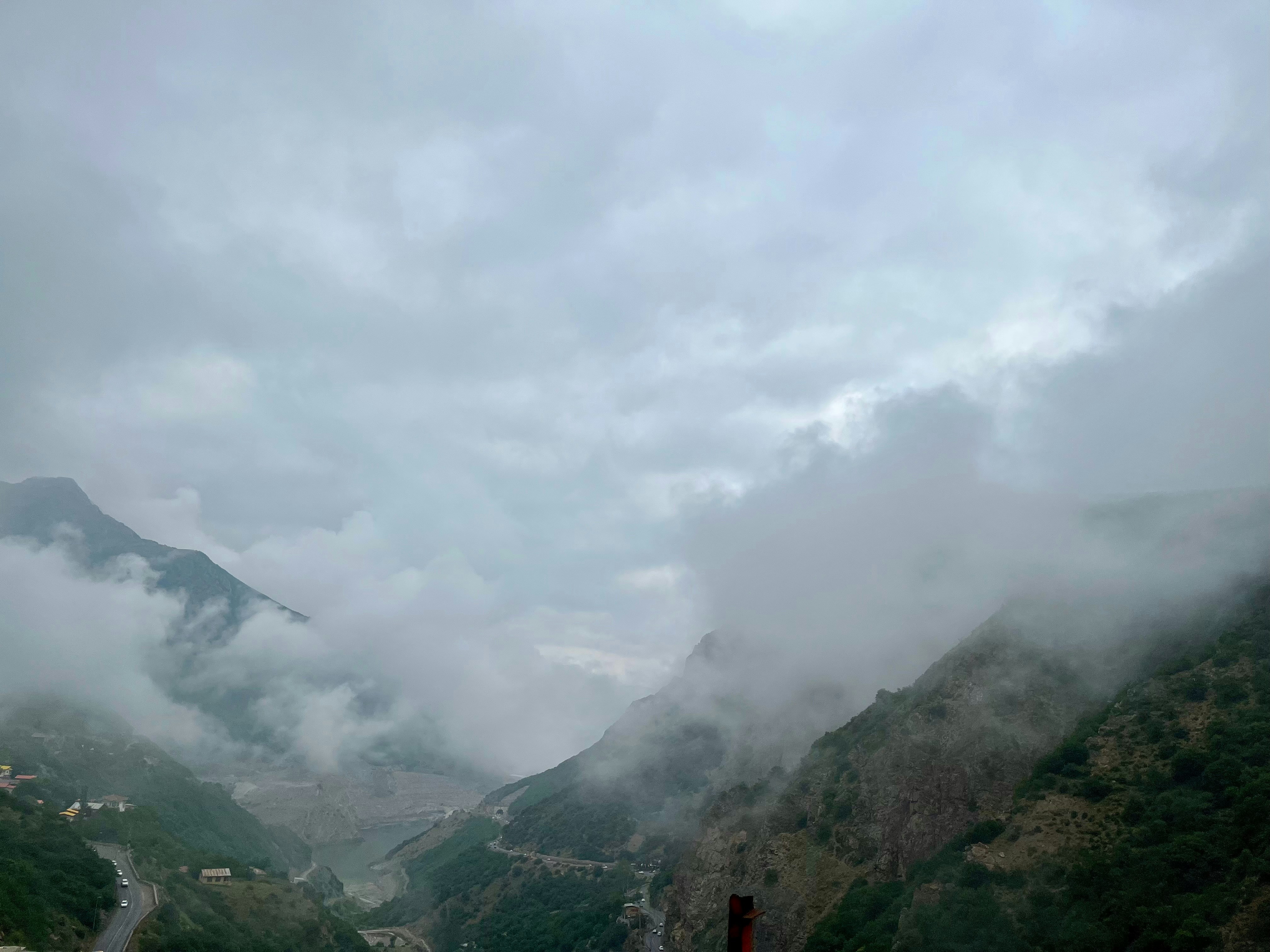 Misty mountains with clouds obscuring the peaks.