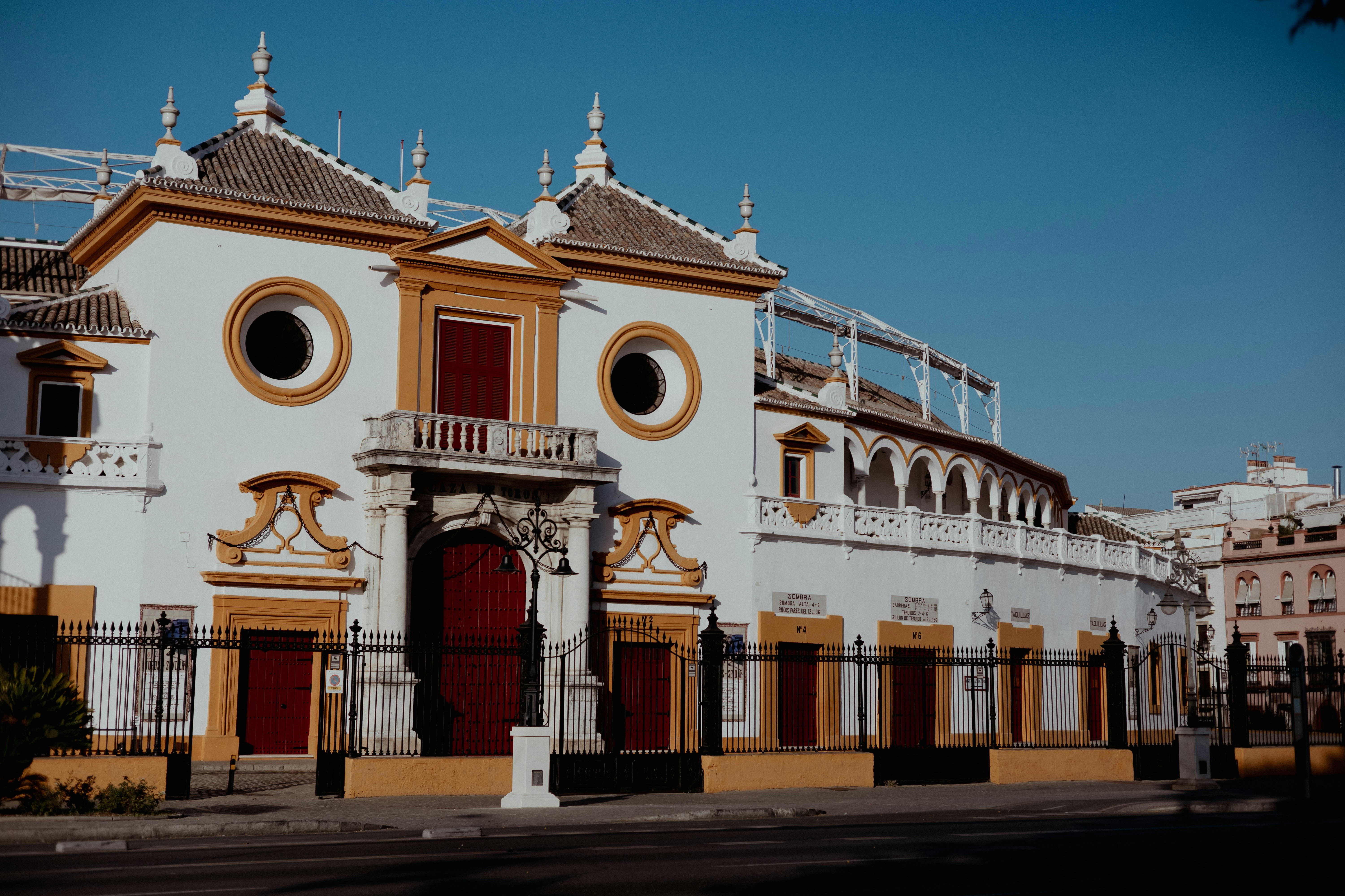 Ornate white building with red doors and windows