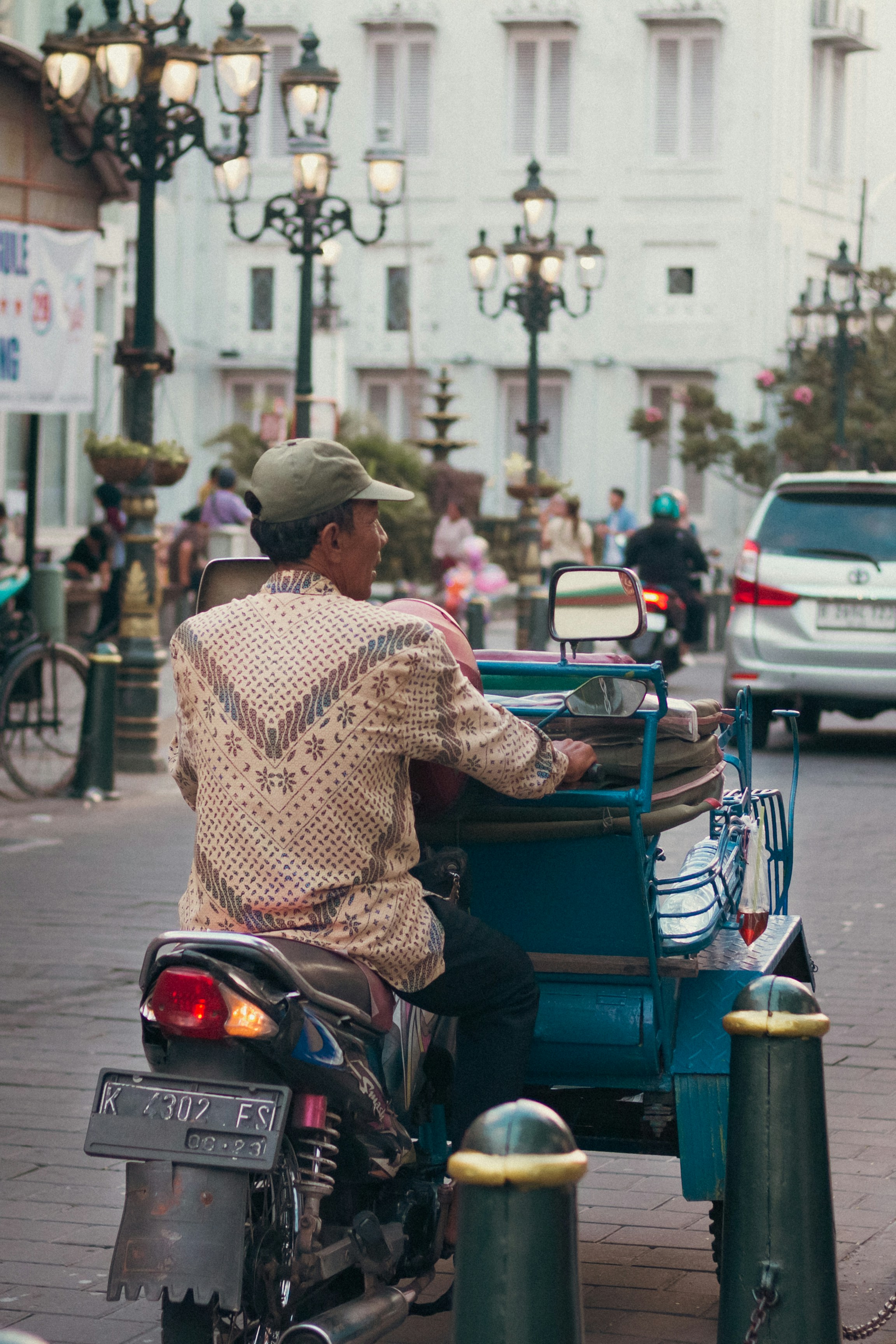 Man driving a motorcycle with a carriage
