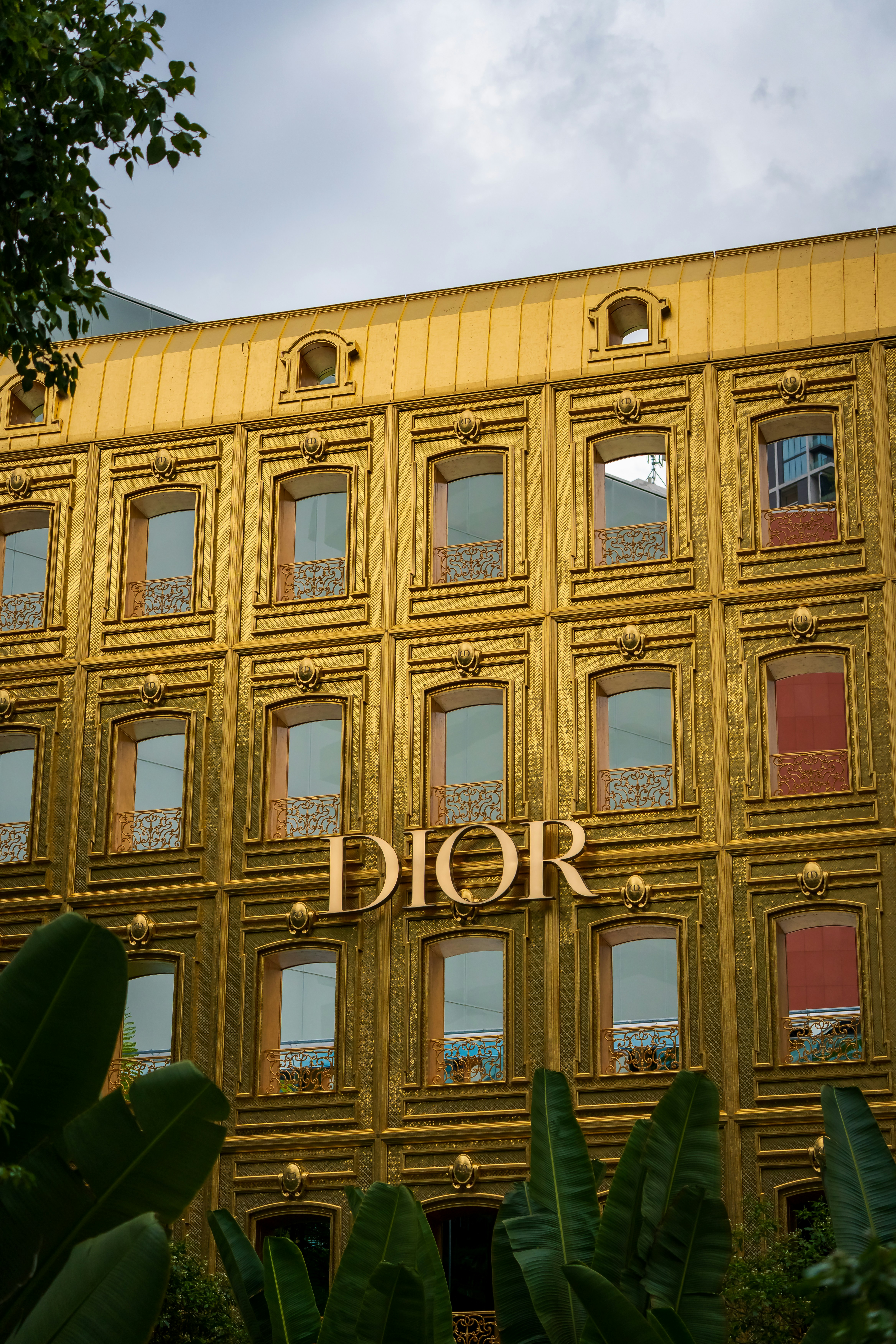 Ornate golden building facade with dior logo photo – Free City Image on ...