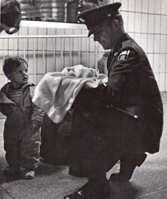 Soldier offers blanket to a child