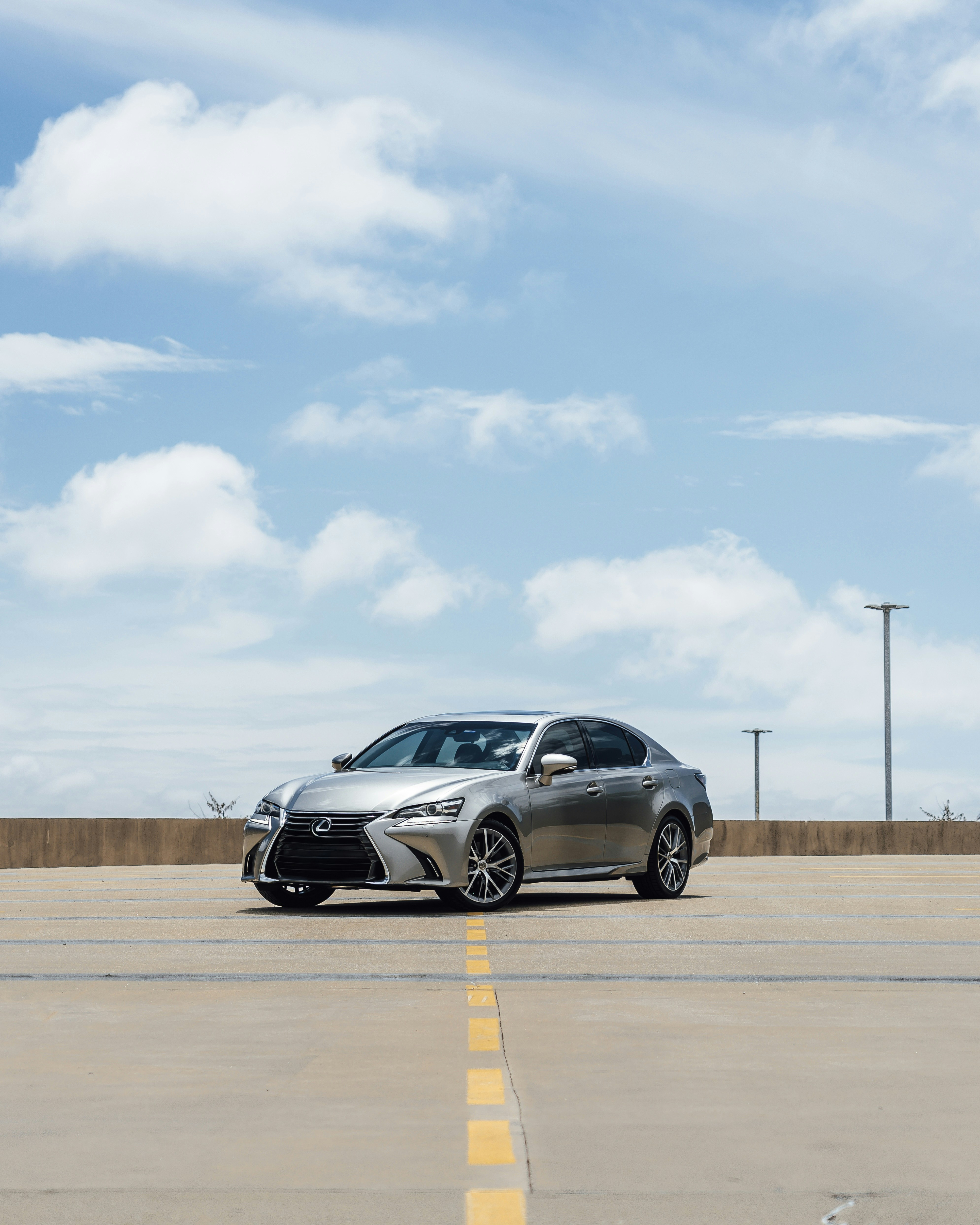 Silver lexus sedan parked on a concrete lot