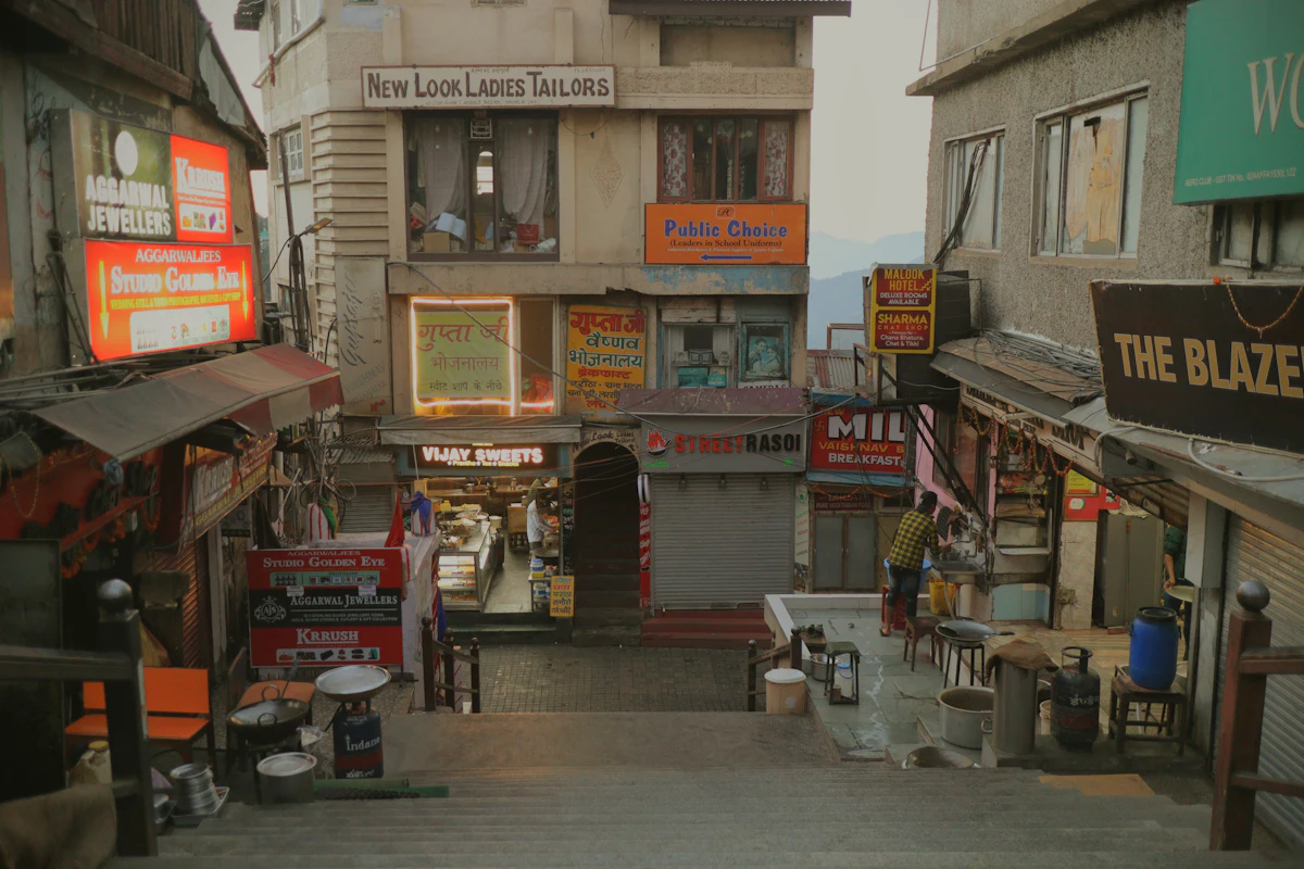 Shops opening along a busy Indian market street