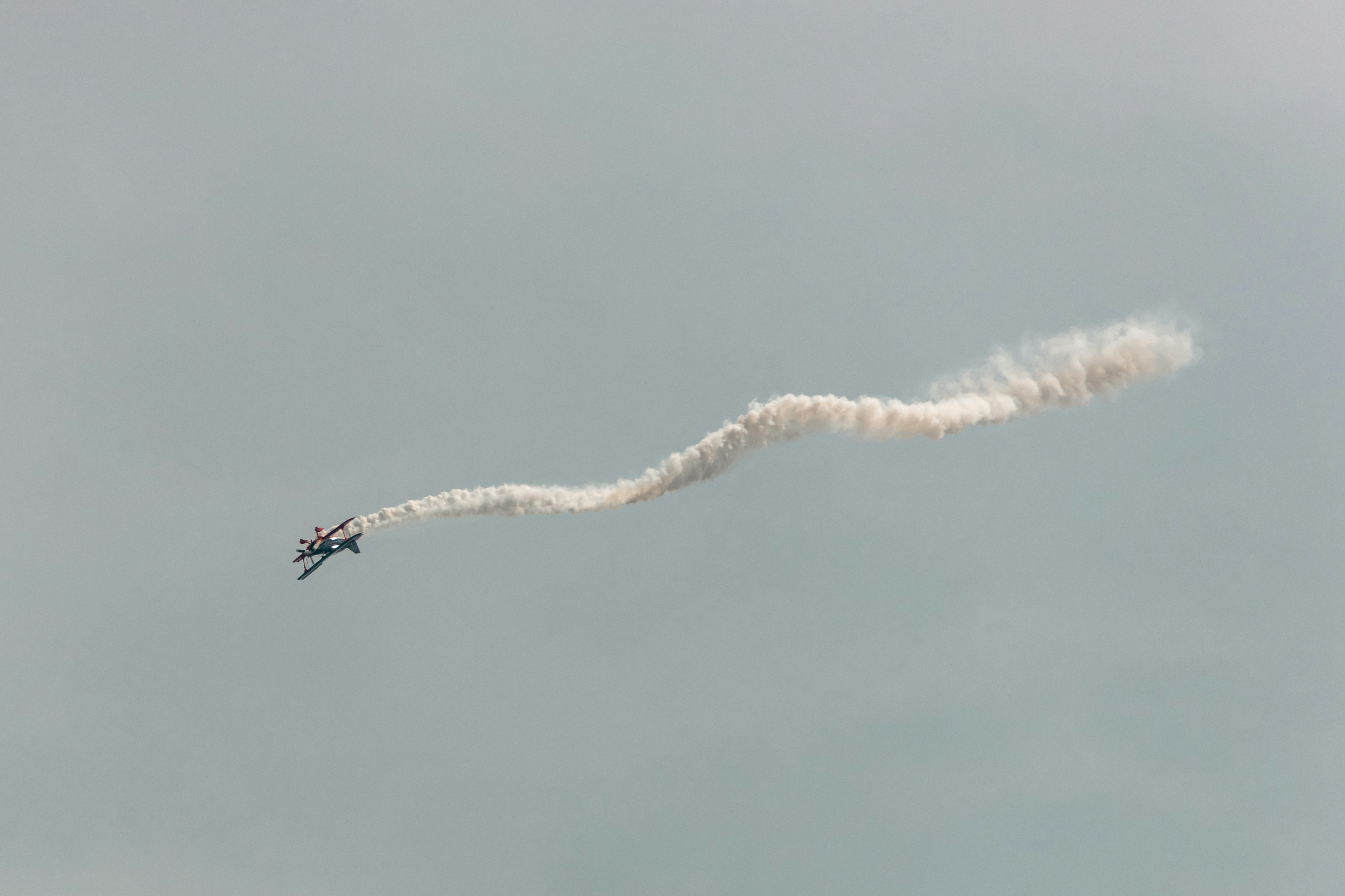 Airplane performing aerobatics with smoke trail