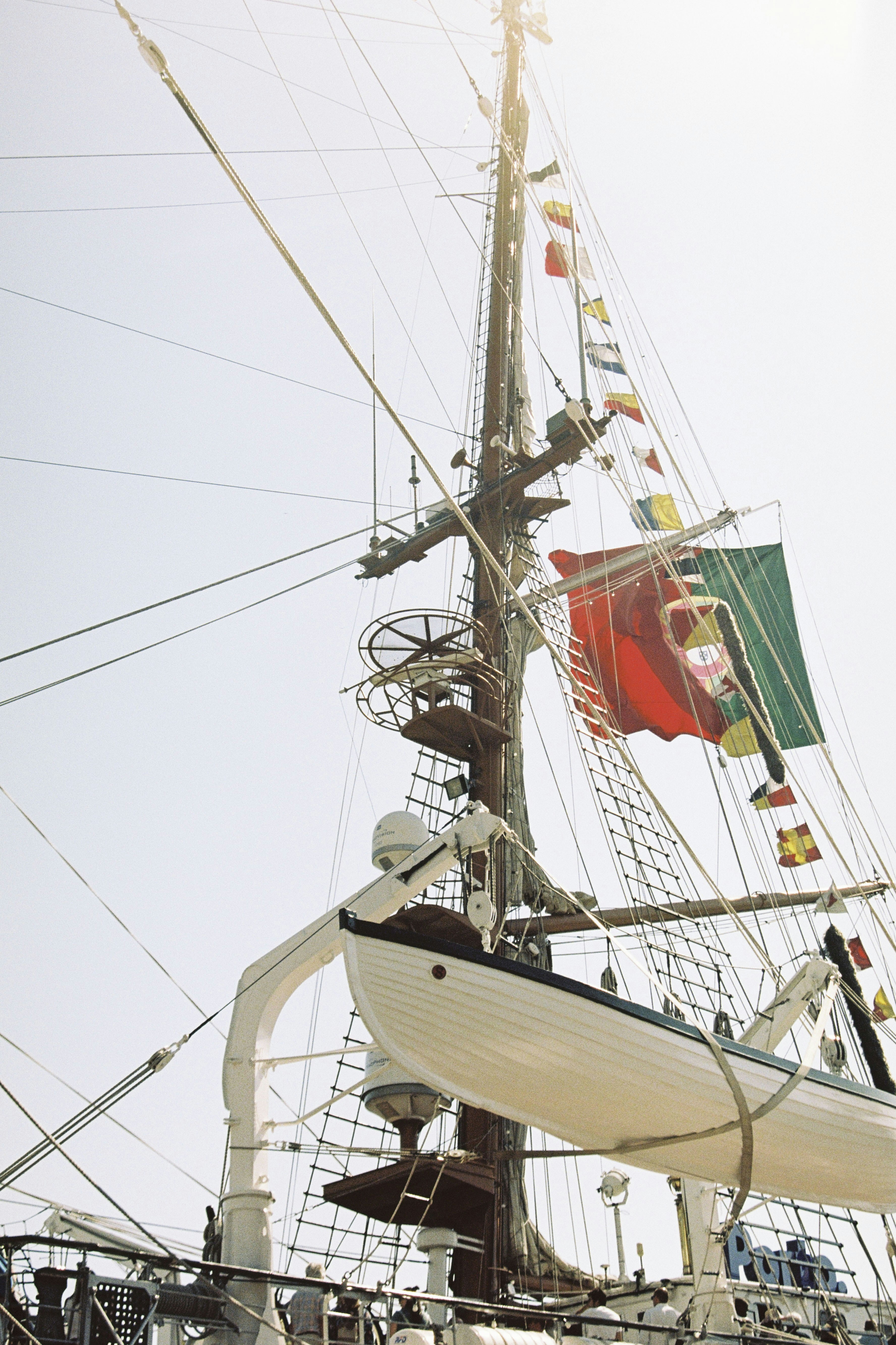 Tall ship mast with portuguese flag and lifeboat