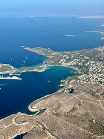 Aerial view of a coastal town with a bay and boats