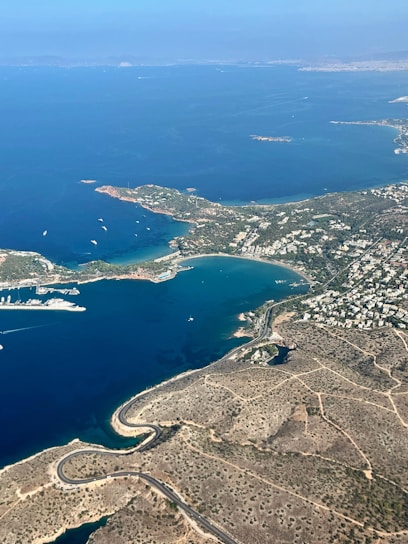 Aerial view of a coastal town with a bay and boats