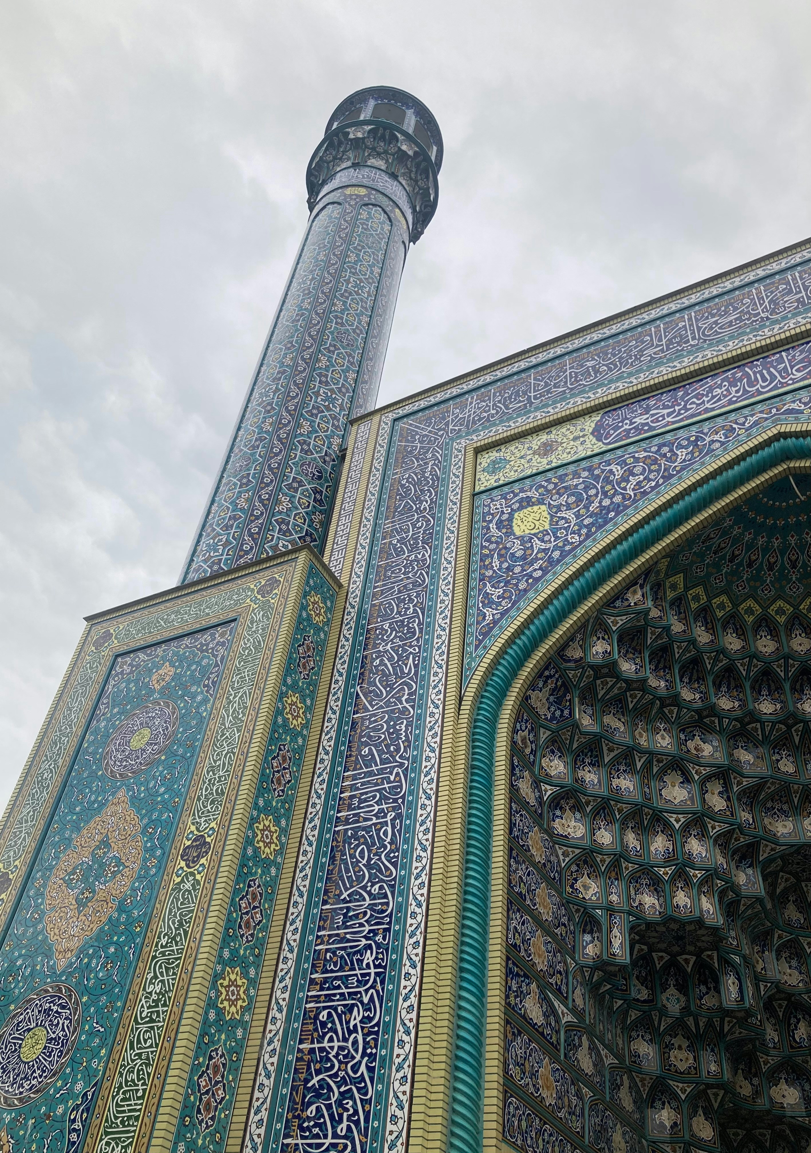 Ornate mosque minaret and entrance with detailed tilework