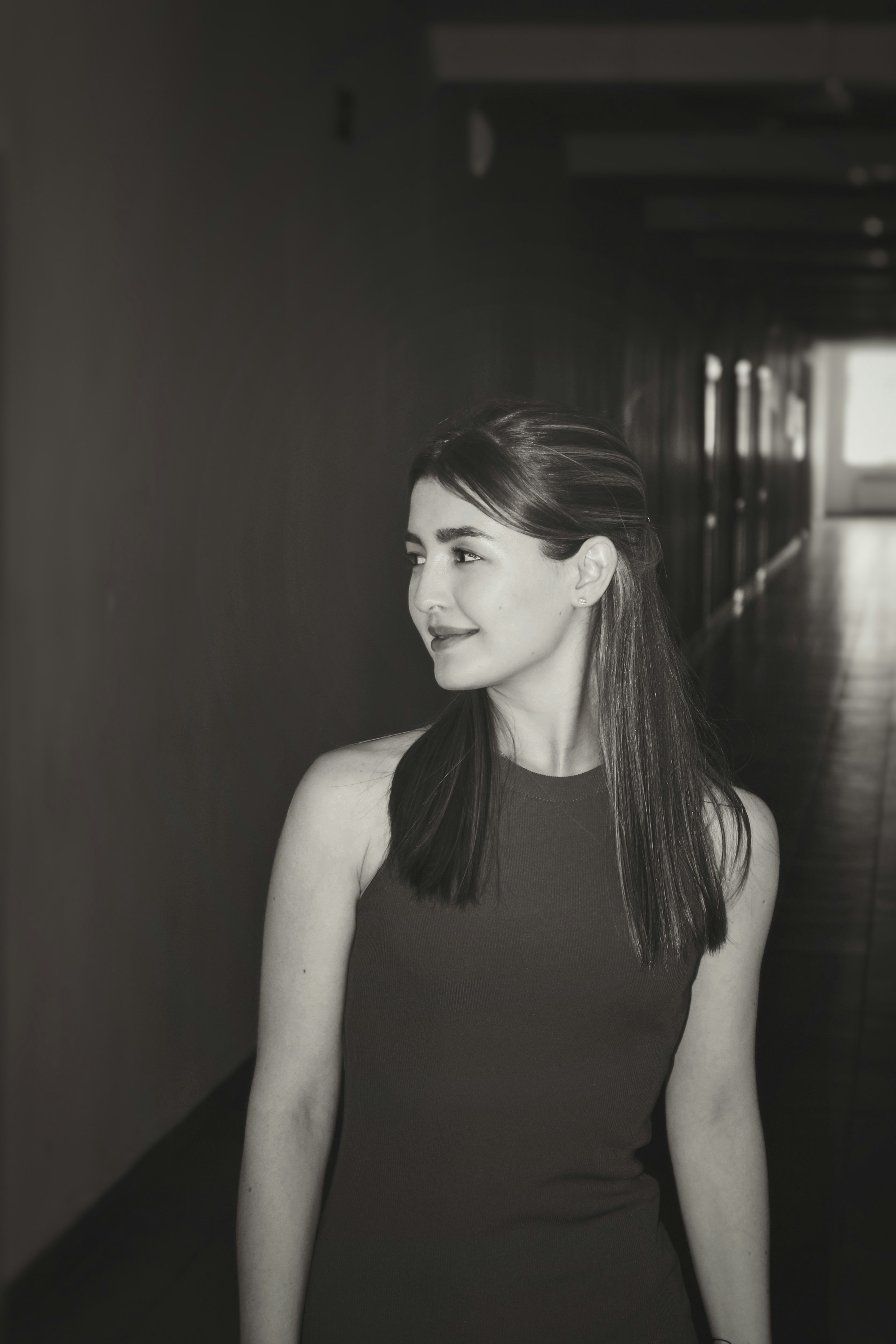 Young woman in a dark dress looking away