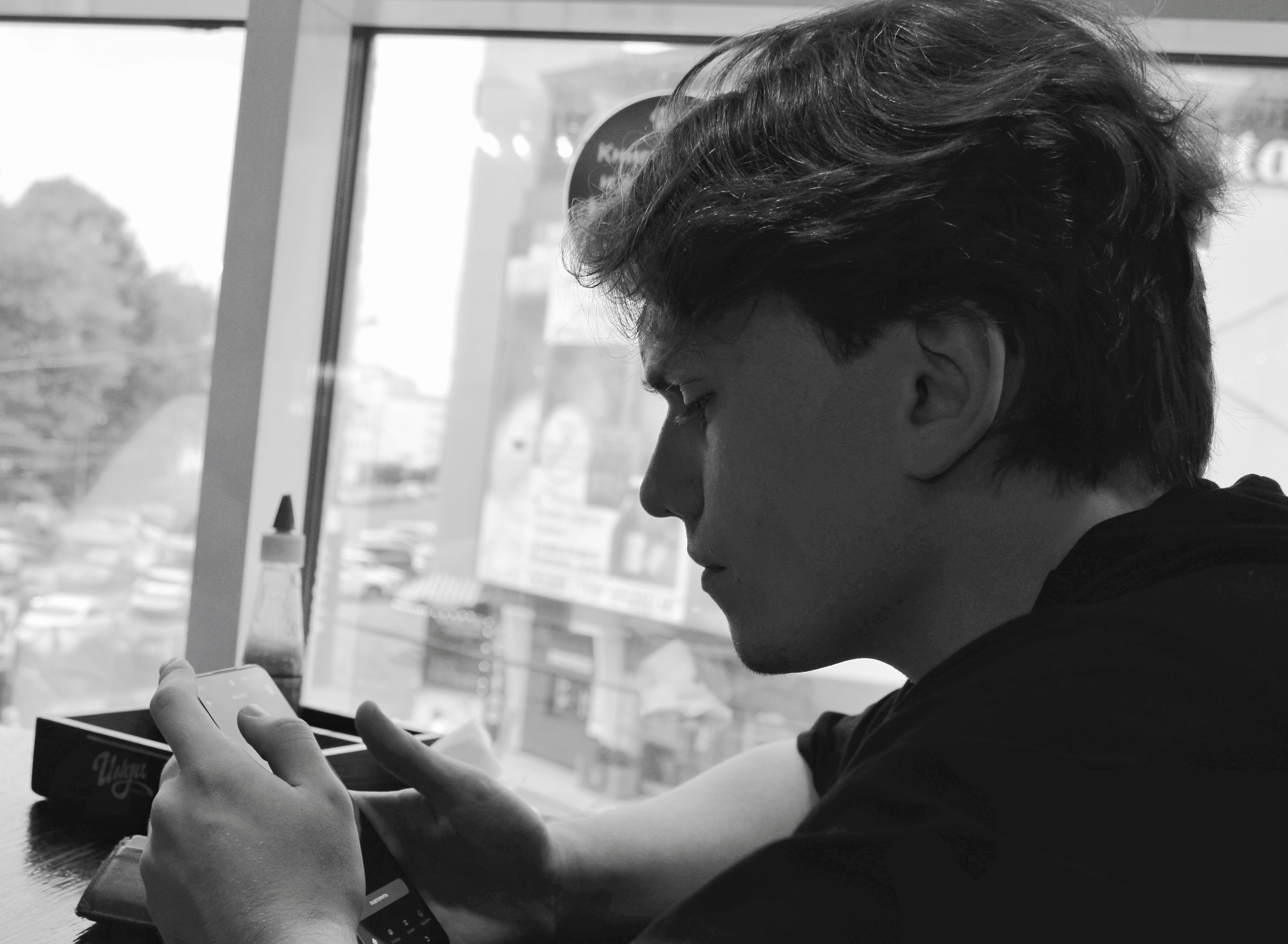 Young man looking down at something in his hands