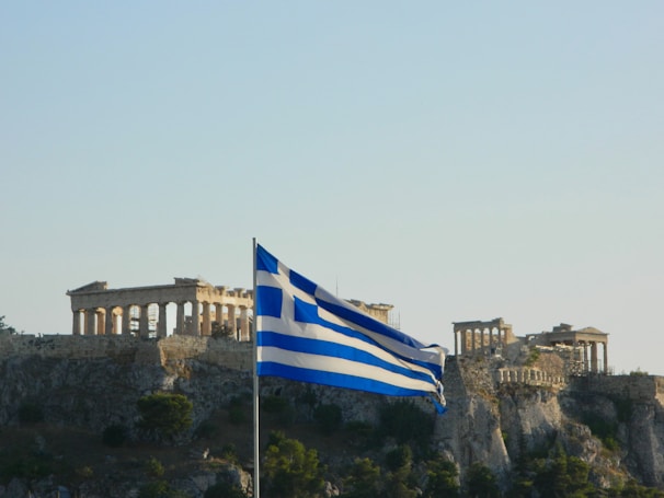 Greek flag waving with the acropolis in the background