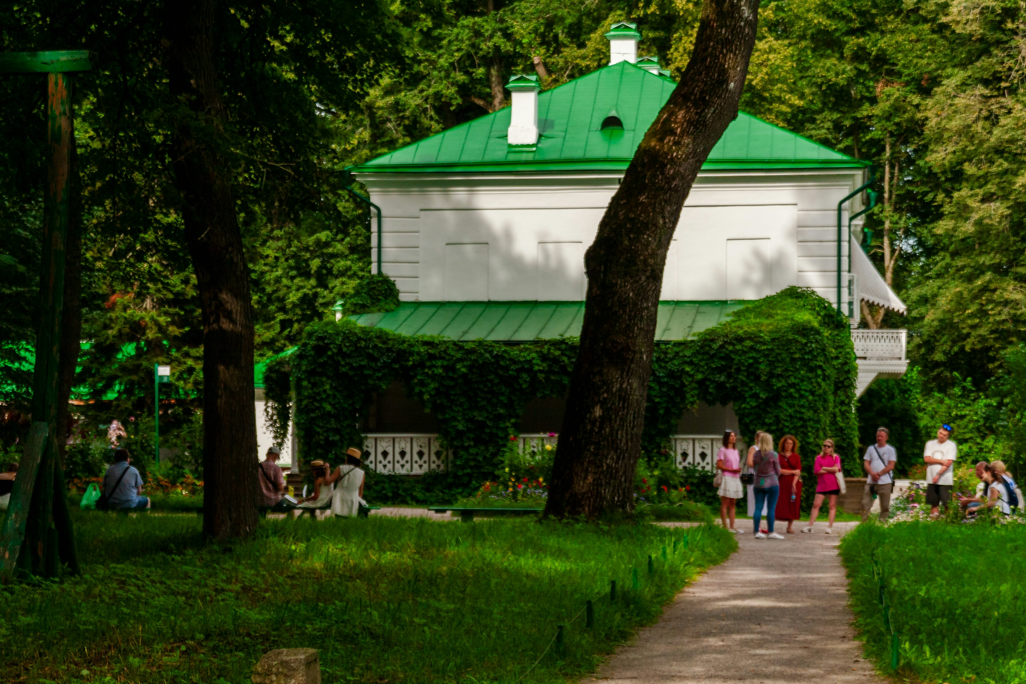 White house with green roof in a park