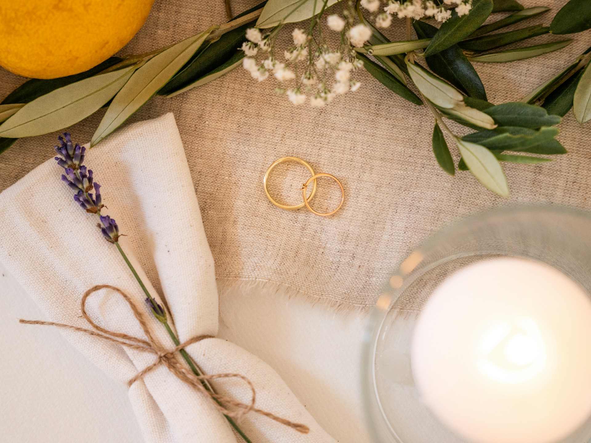 Wedding rings with lavender and candle on table