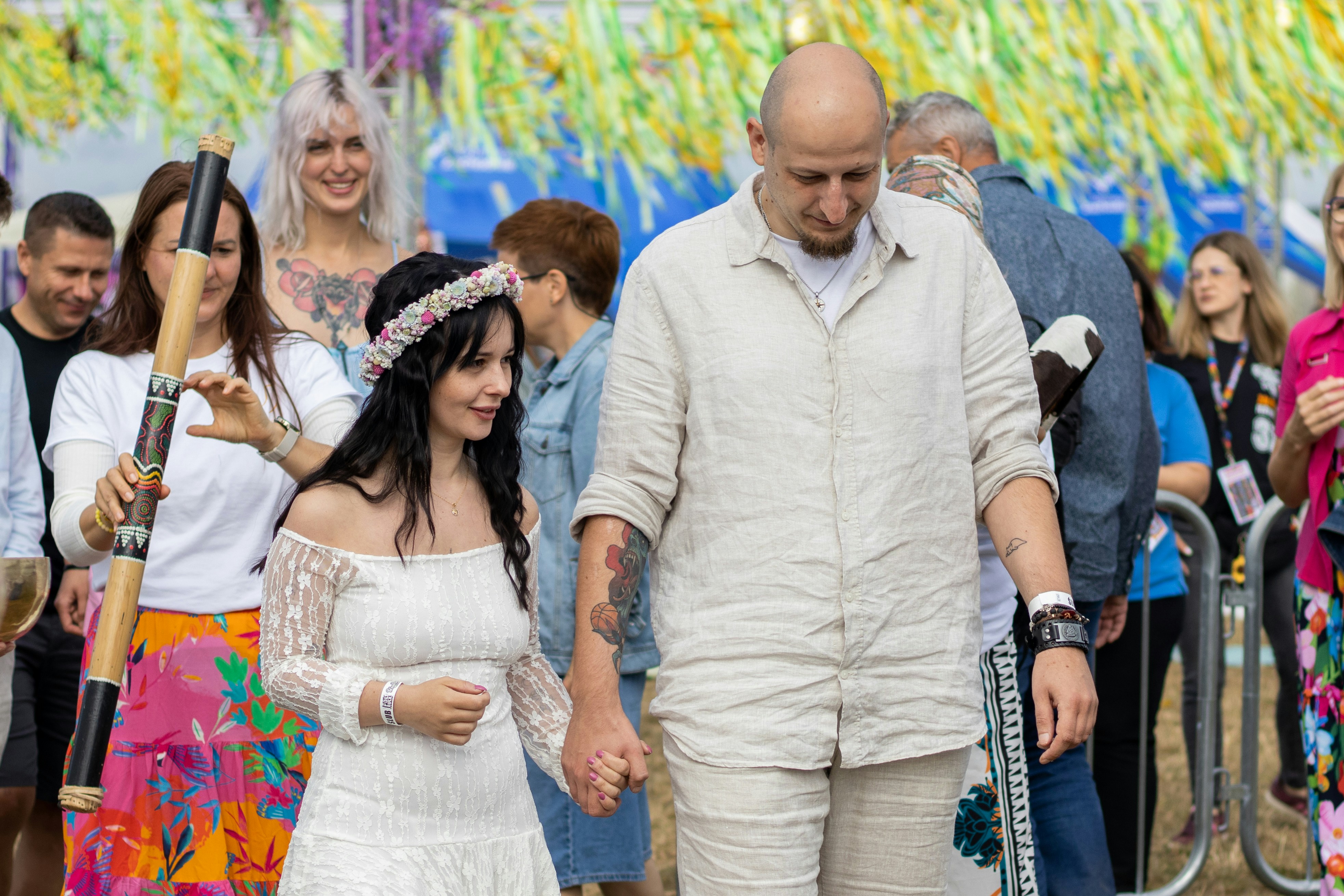 Couple walking hand-in-hand at an outdoor event