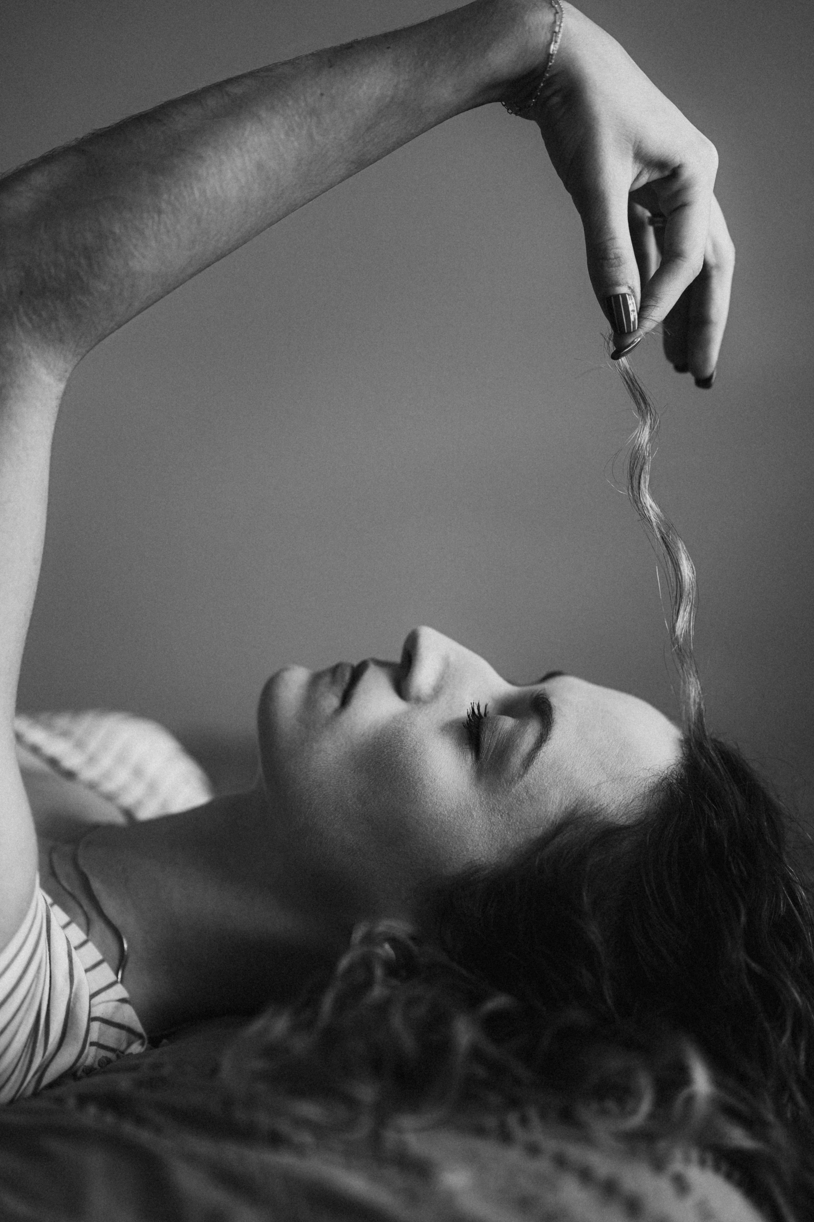 Woman holding a strand of her wavy hair