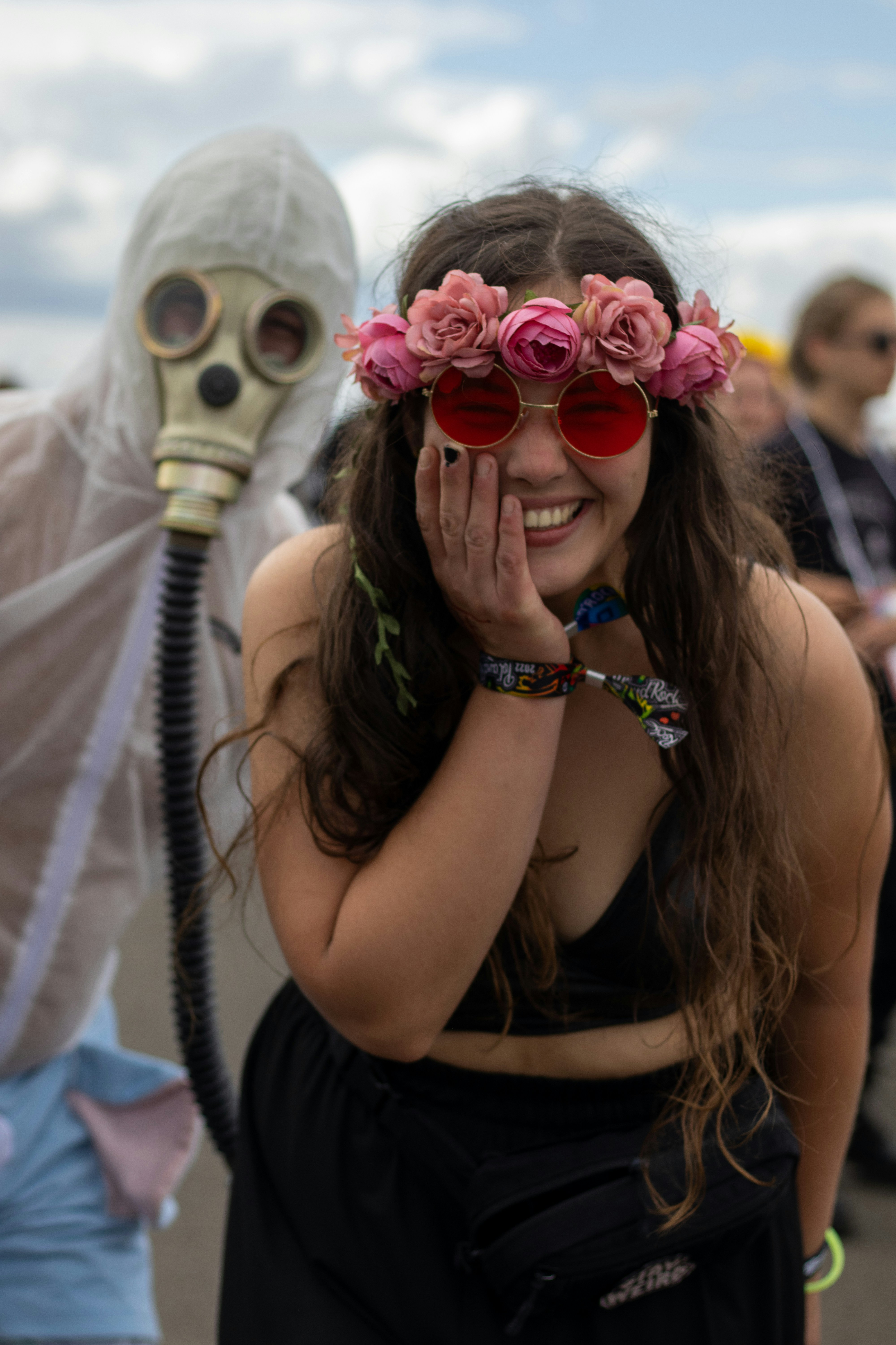 Woman with flower crown and person in hazmat suit