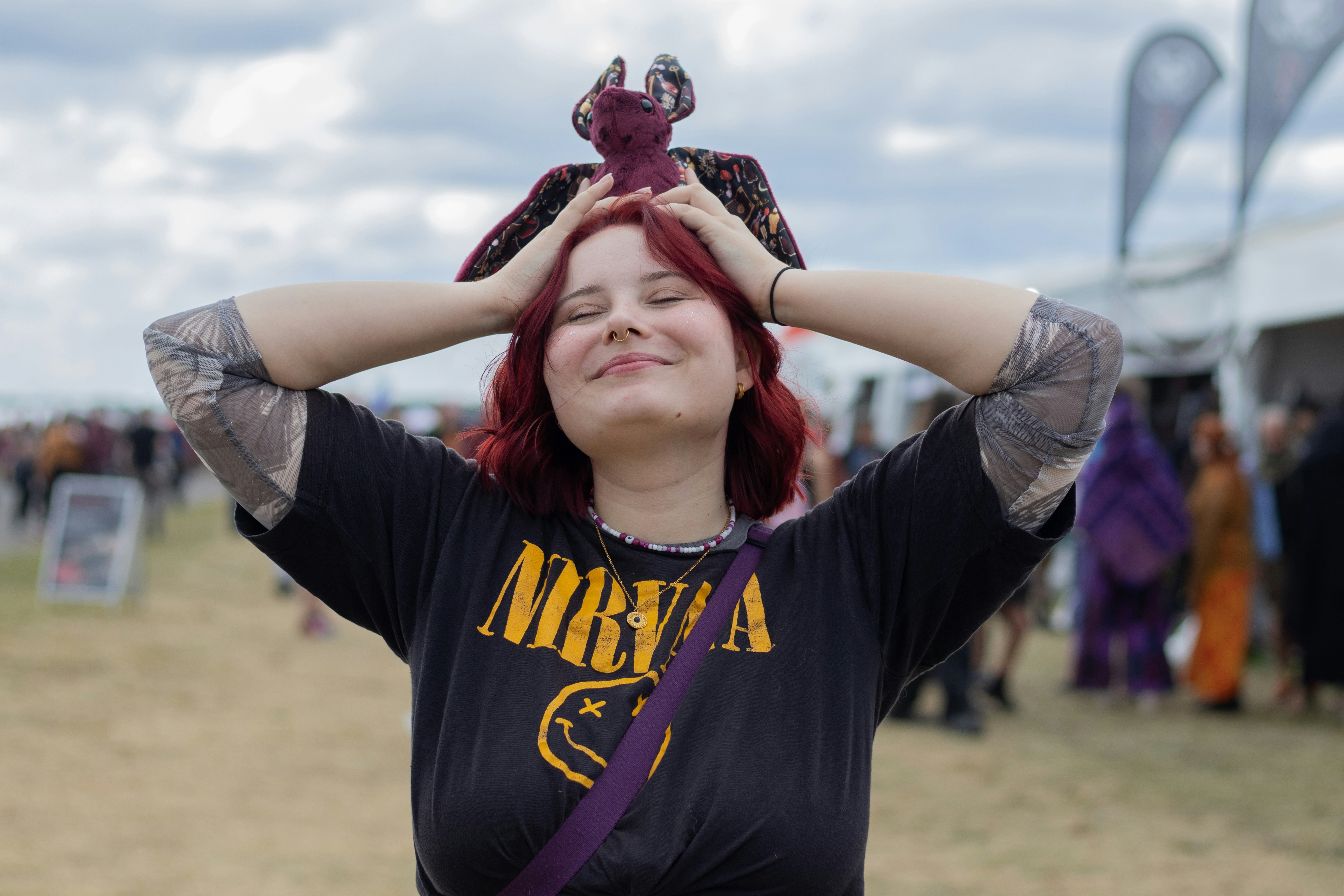 Young woman with red hair wearing nirvana t-shirt