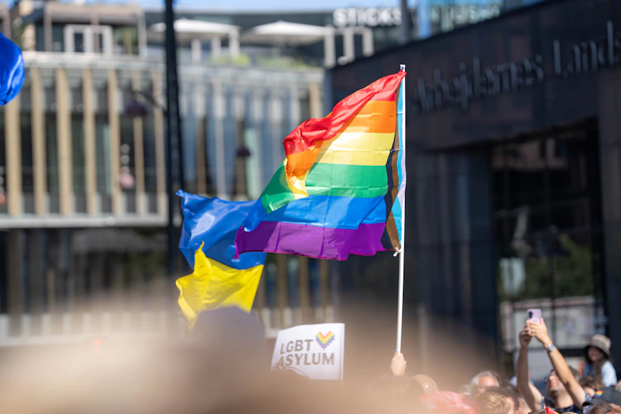 Rainbow flag waving beside a building, a visible symbol for people exploring free queer dating apps without payment