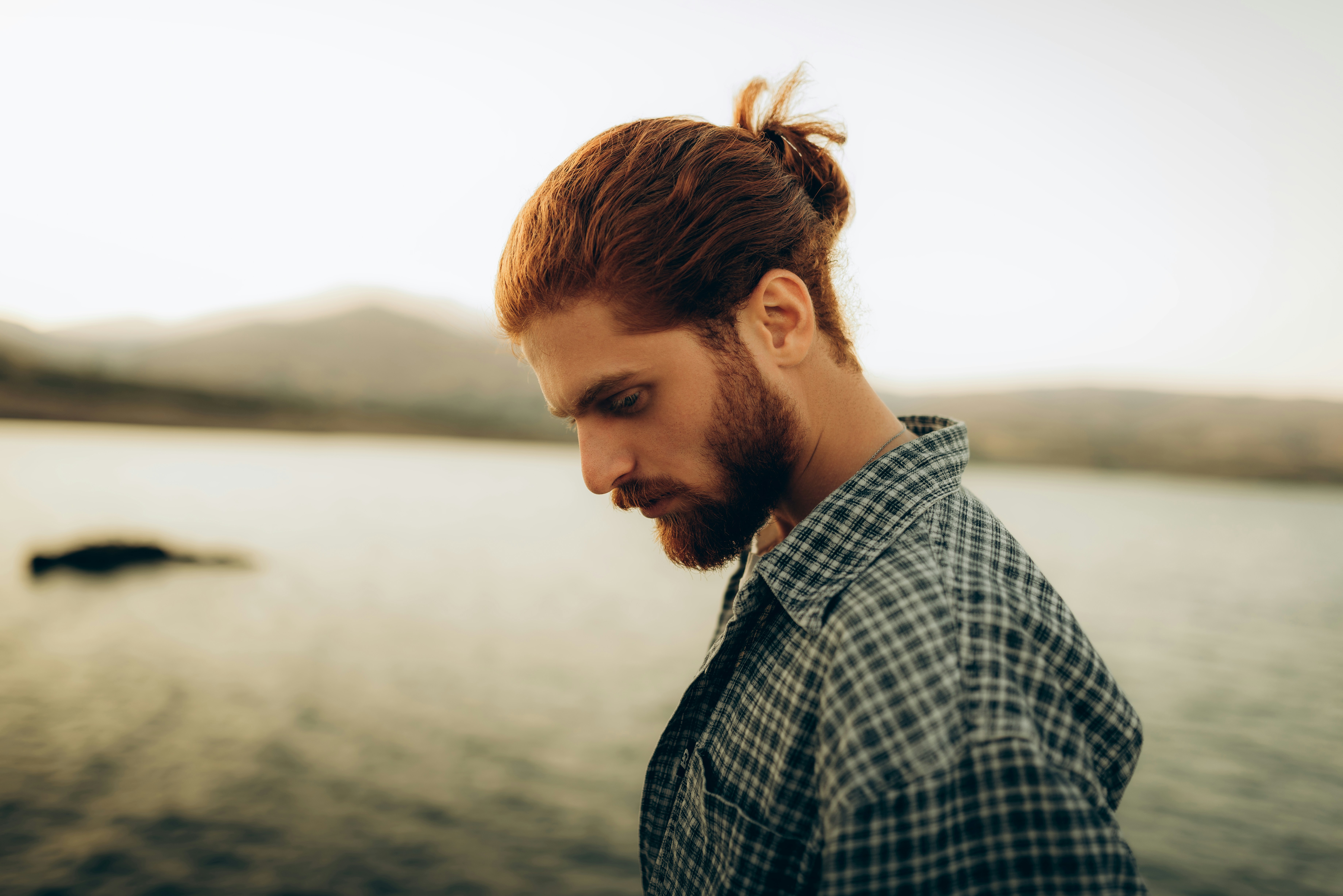 Man with red hair and beard by the water