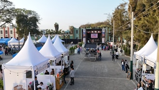 Outdoor festival with tents and a stage