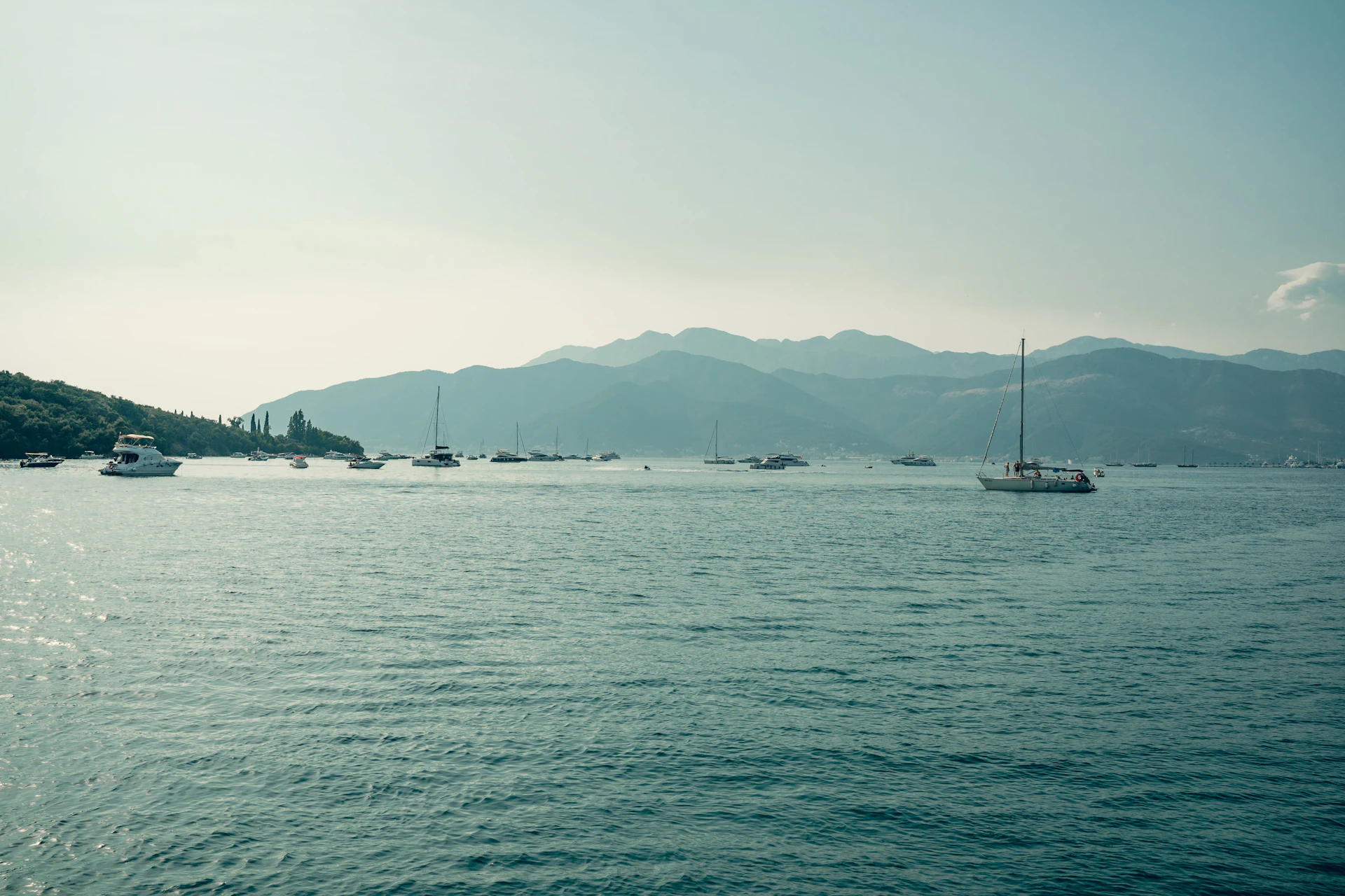 Sailboats in the bay at Tivat with mountains in the distance