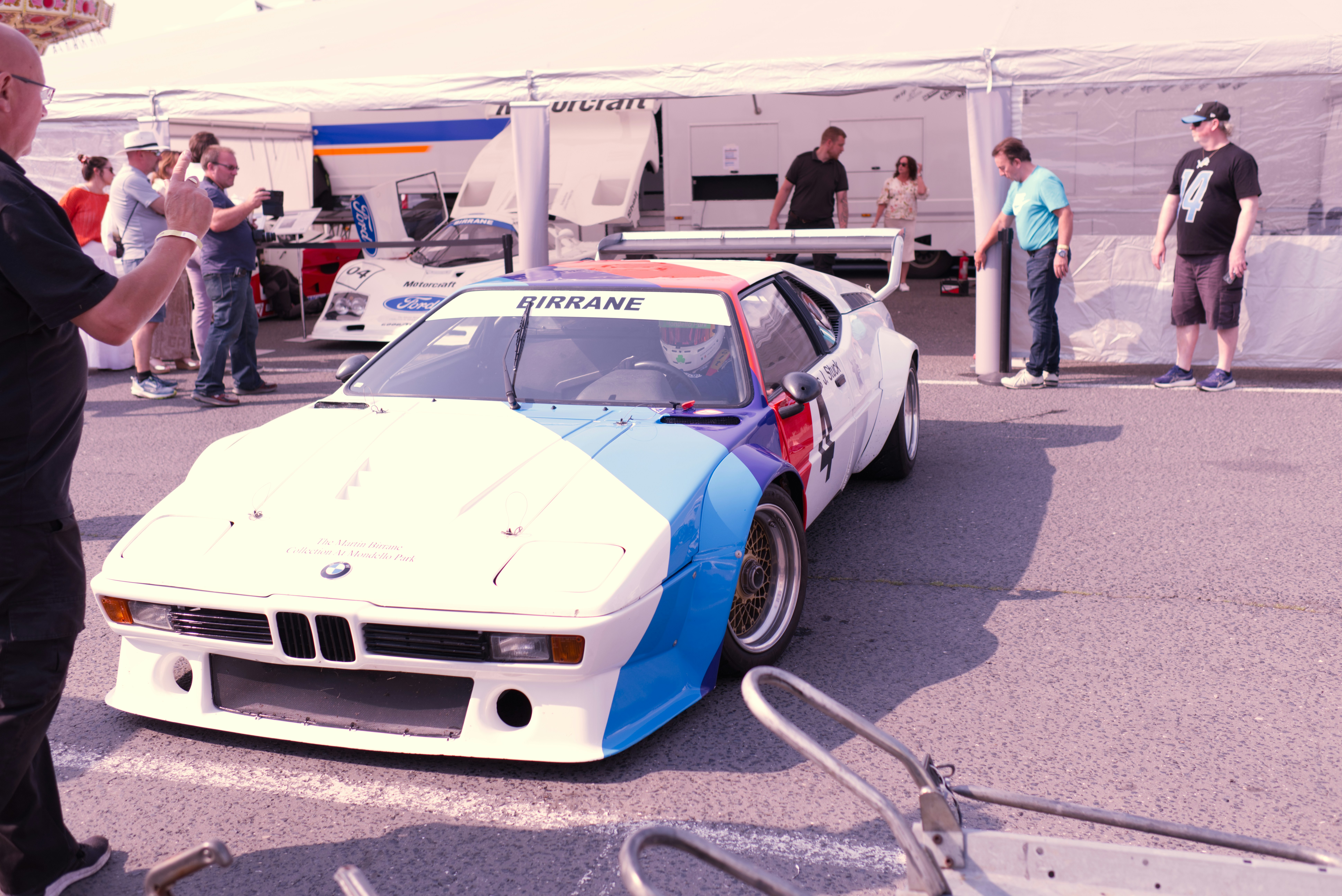 White race car with blue and red stripes