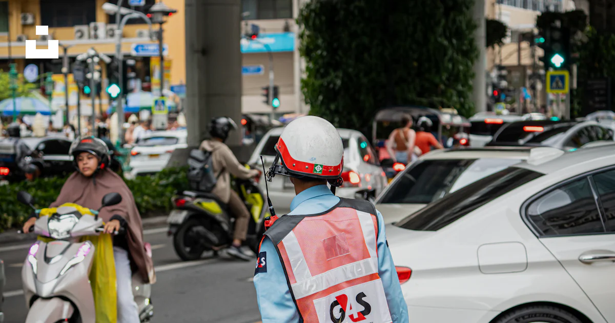 Directing Vehicles Traffic controller directing vehicles on a busy street. photo – Free ...