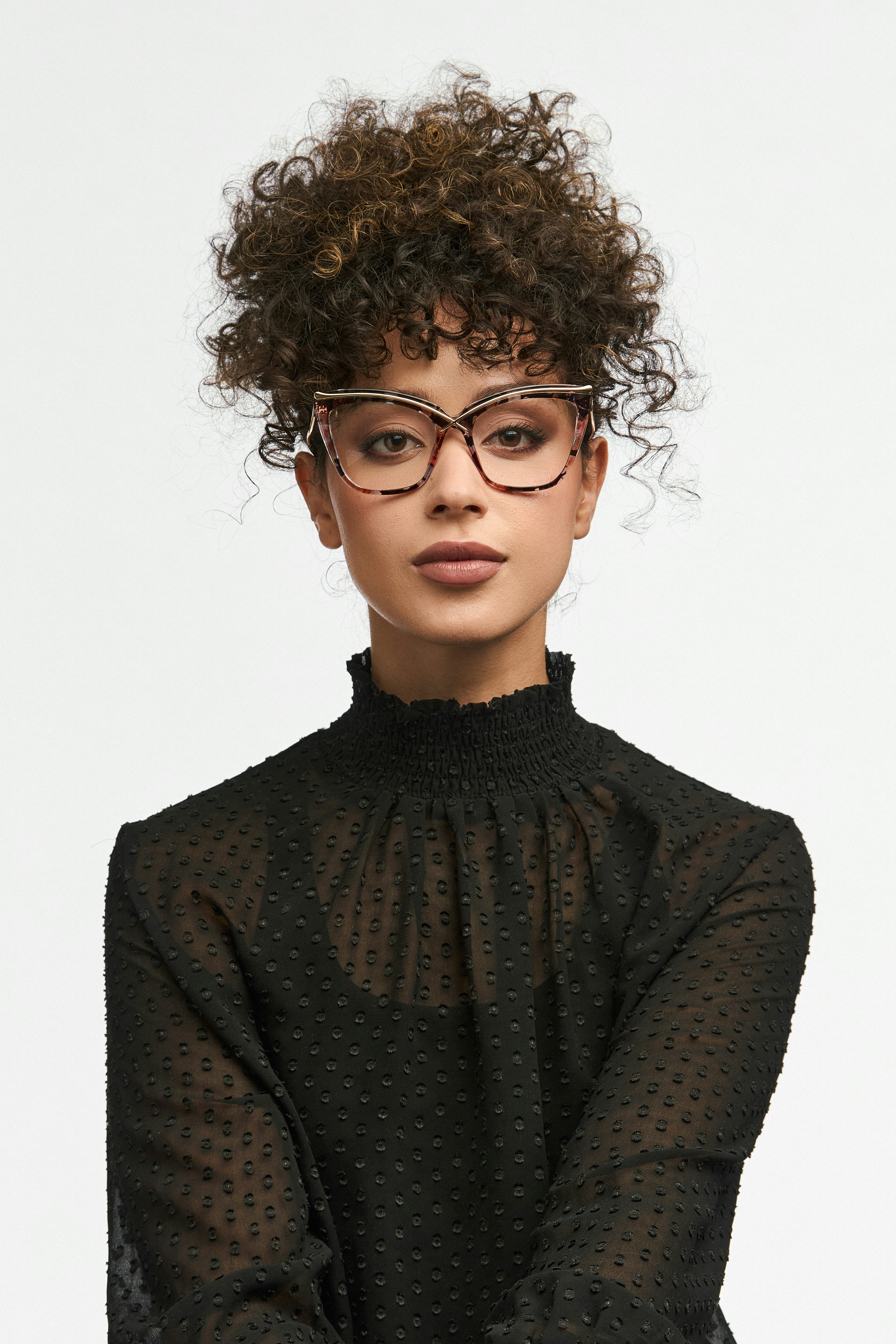 A close-up of a person's face, with a focus on their modern, well-fitting glasses.