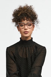 Woman with curly hair wearing glasses and black shirt