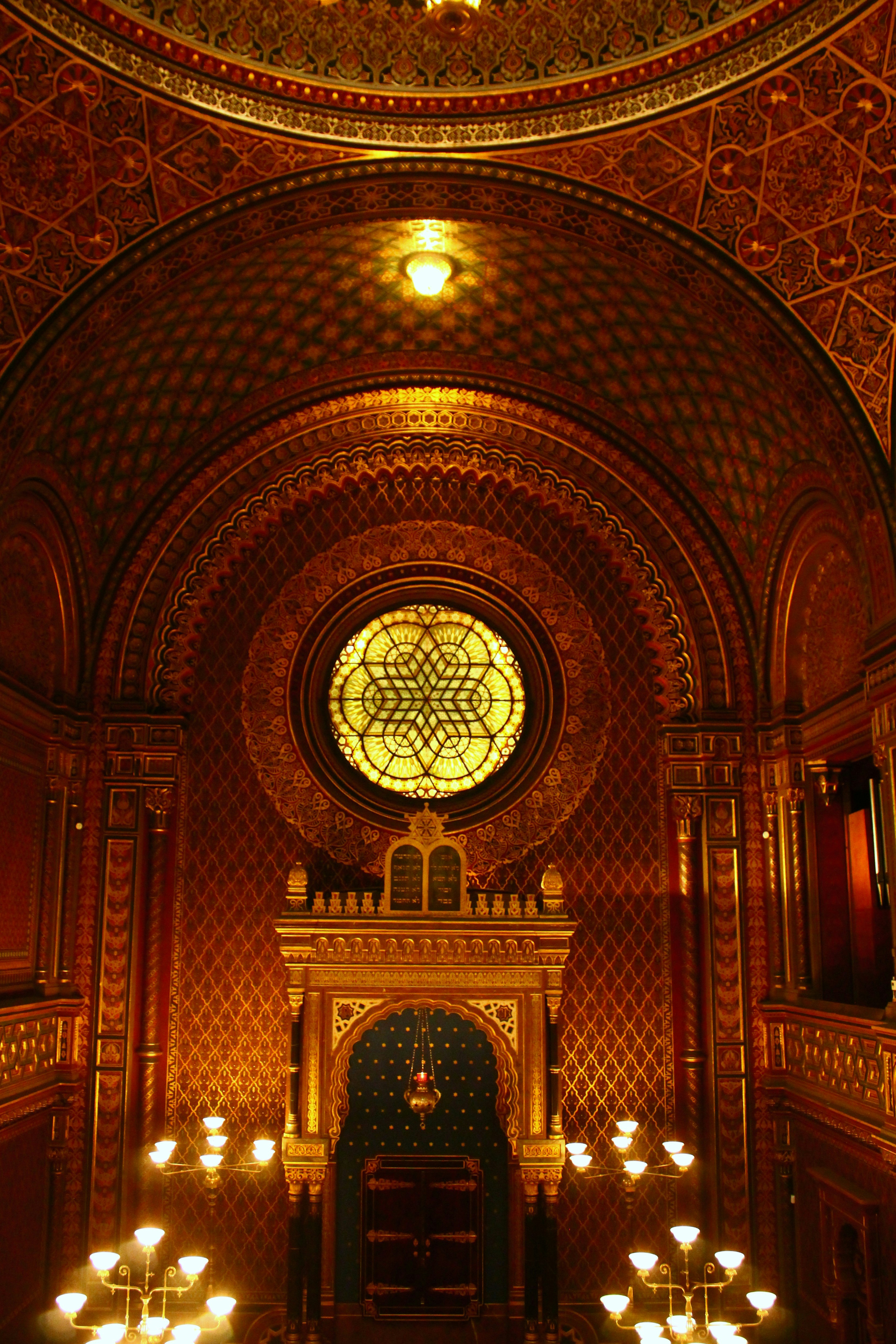 Ornate interior of a historic synagogue with stained glass.
