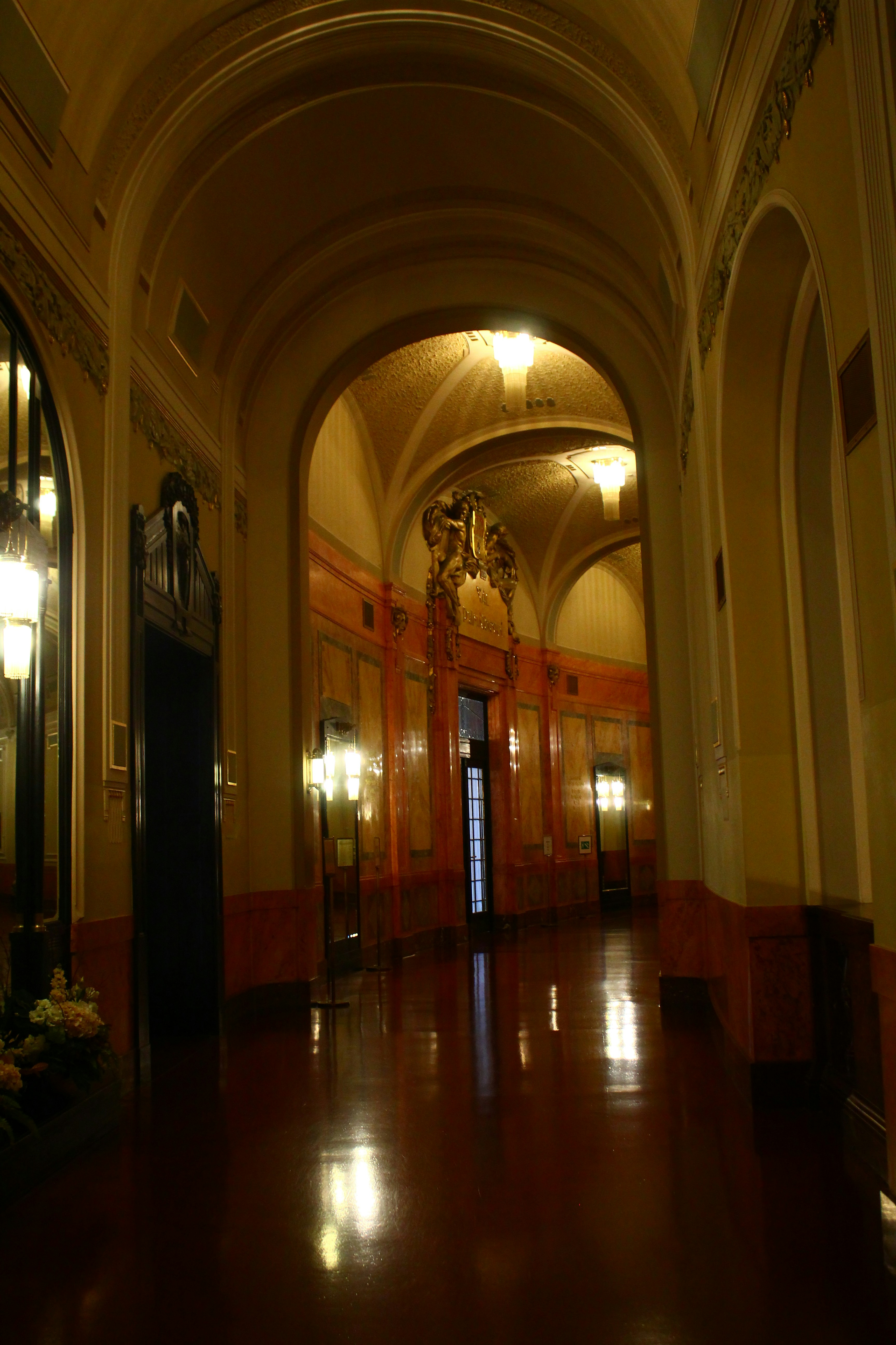 Ornate hallway with arched ceilings and warm lighting