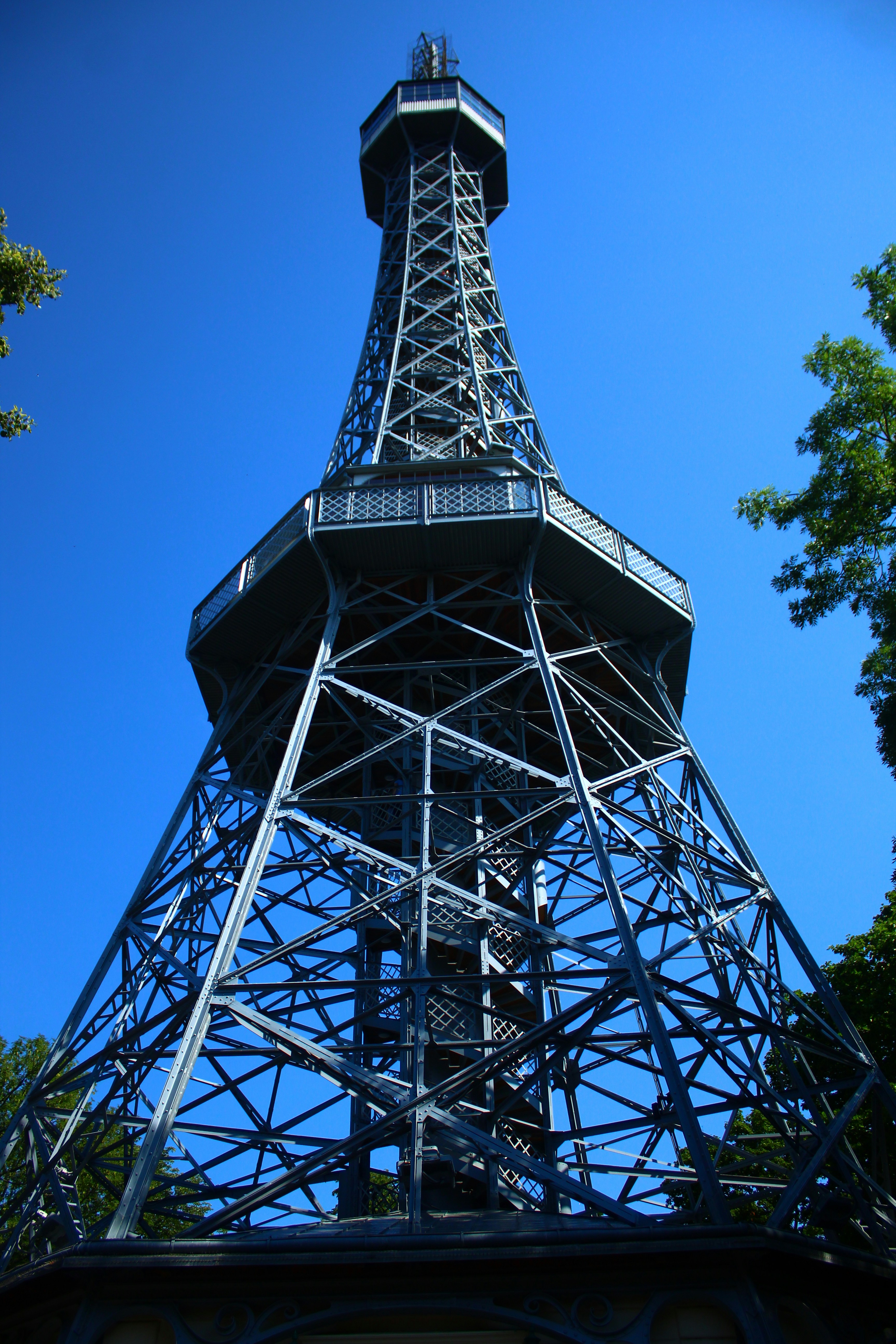 A tall metal observation tower against a clear blue sky.