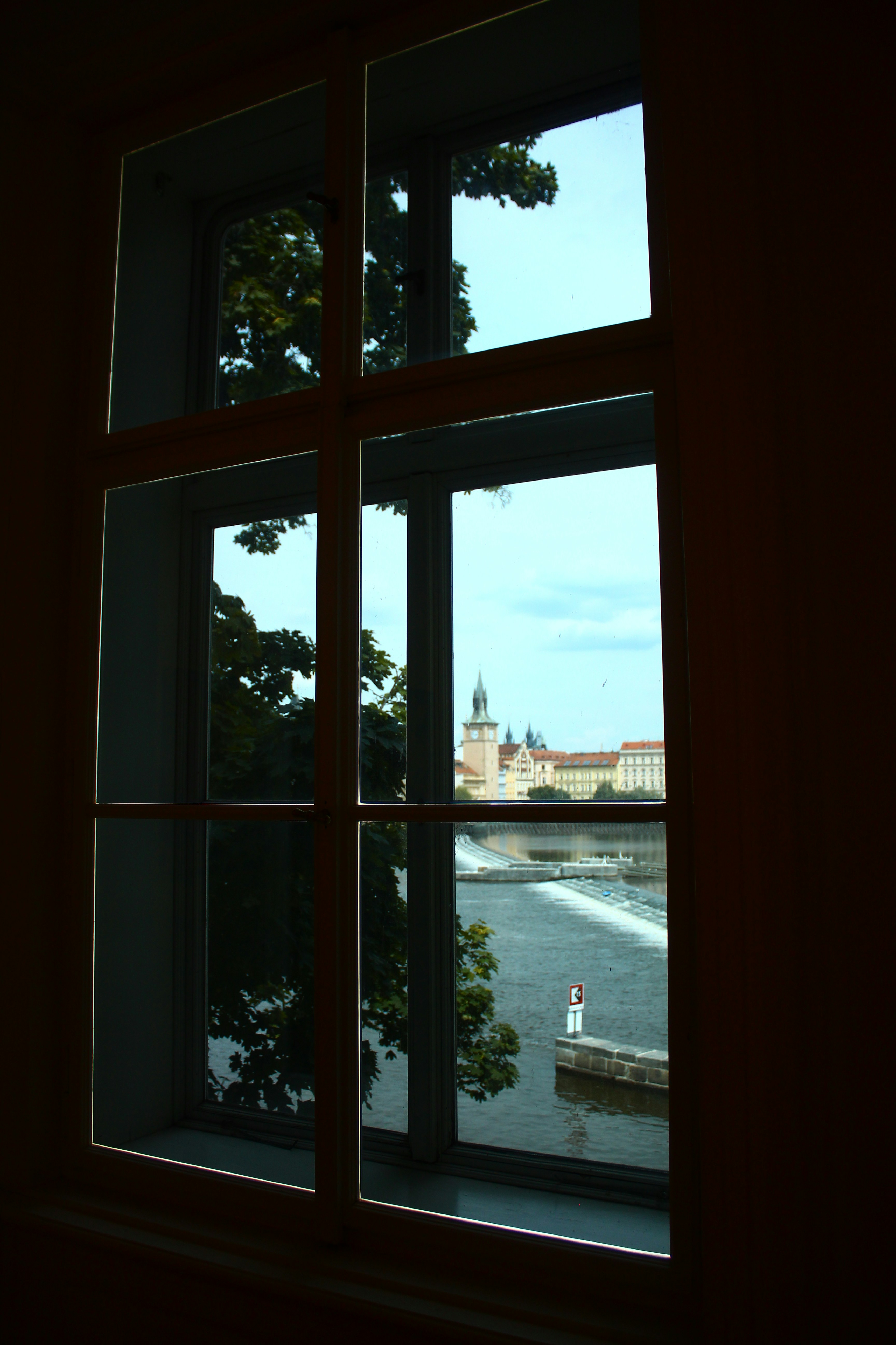 View of a river and buildings through a window.
