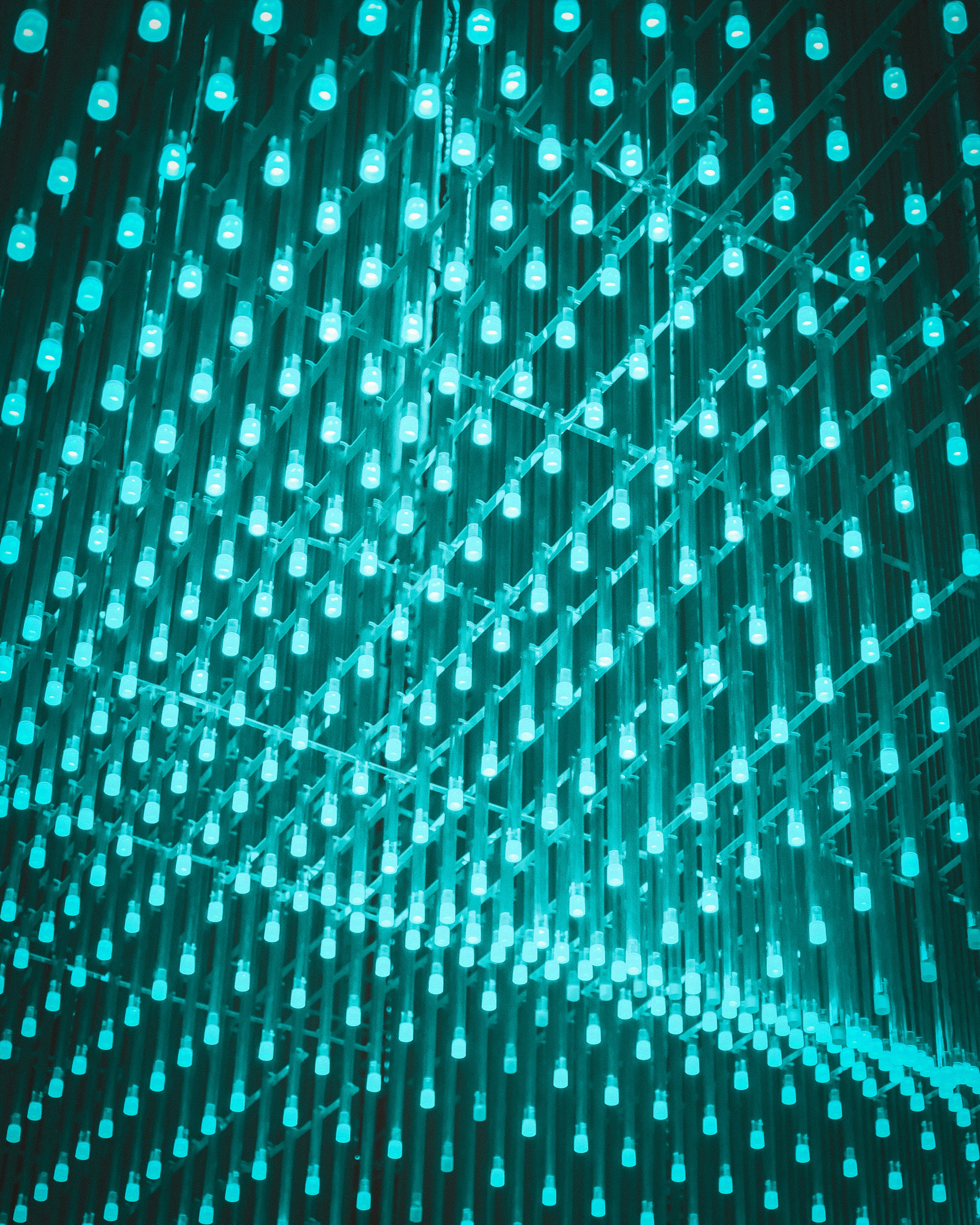 Many glowing teal lights arranged in a grid pattern.