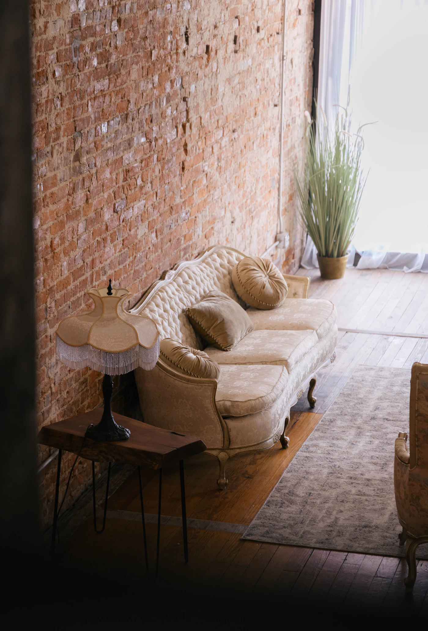 Ornate sofa · brick wall