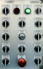 Control panel with multiple switches and emergency stop button