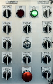 Control panel with multiple switches and emergency stop button