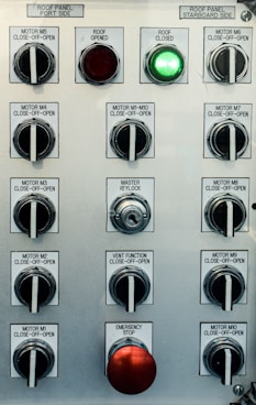 Control panel with multiple switches and emergency stop button