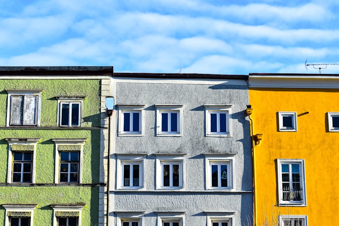 Colorful buildings with windows under a blue sky