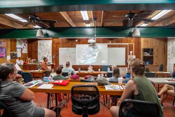 People attending a class with a projector screen