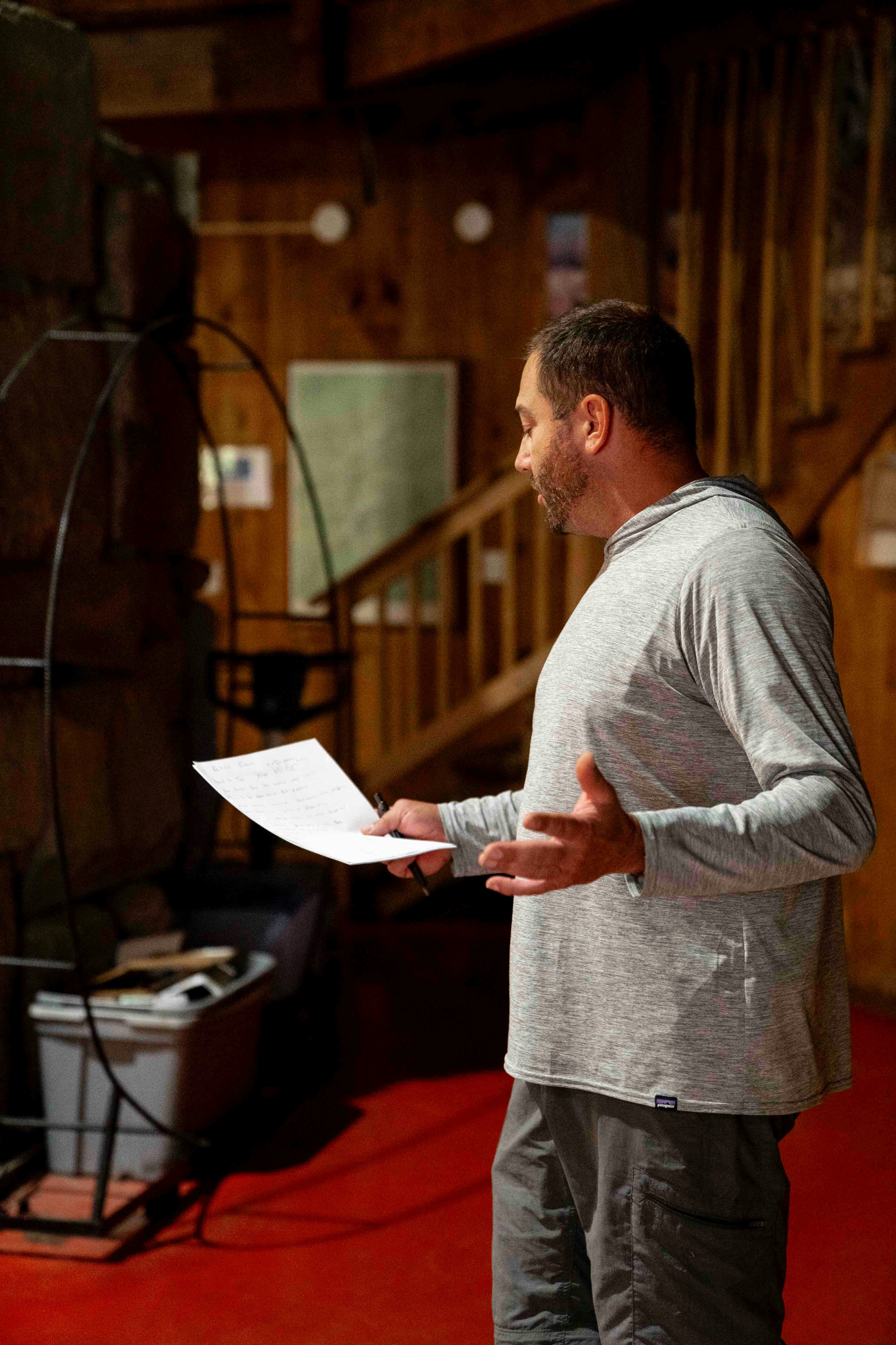 Actor actively rehearsing and testing recall of script lines without looking