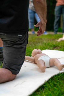 Man practicing infant cpr on a training dummy