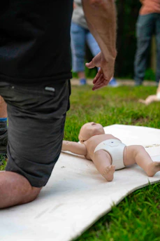 Man practicing infant cpr on a training dummy