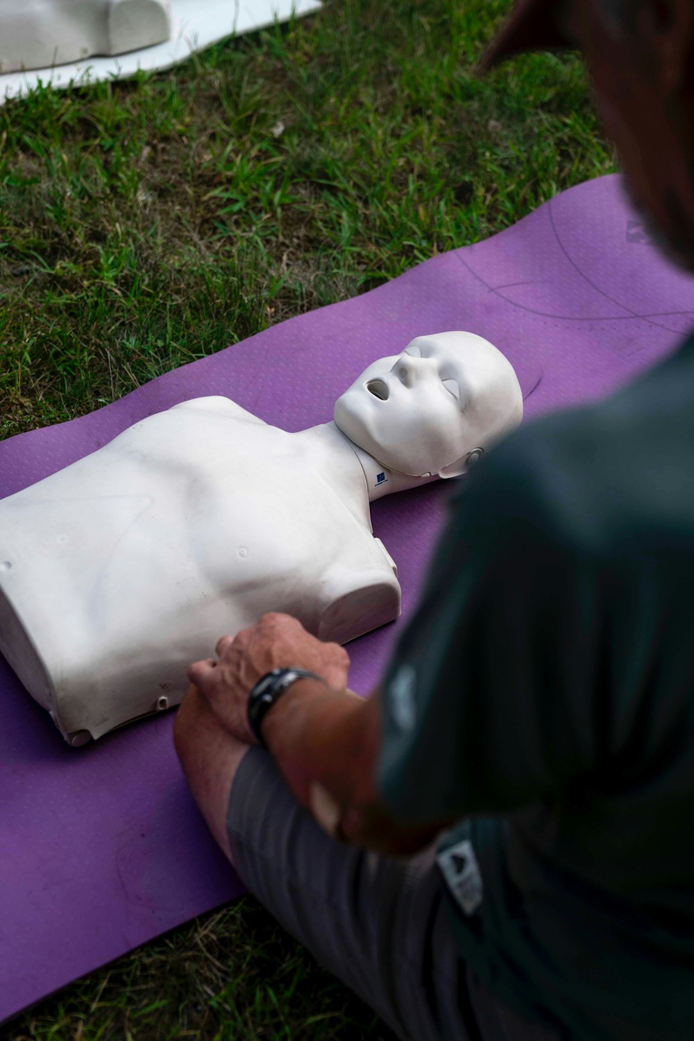 Personne pratiquant le massage cardiaque sur un mannequin lors d'une formation sauveteur secouriste du travail