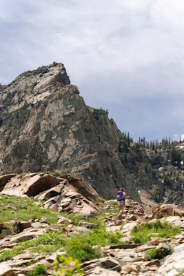 Hiker ascending a rocky mountain trail