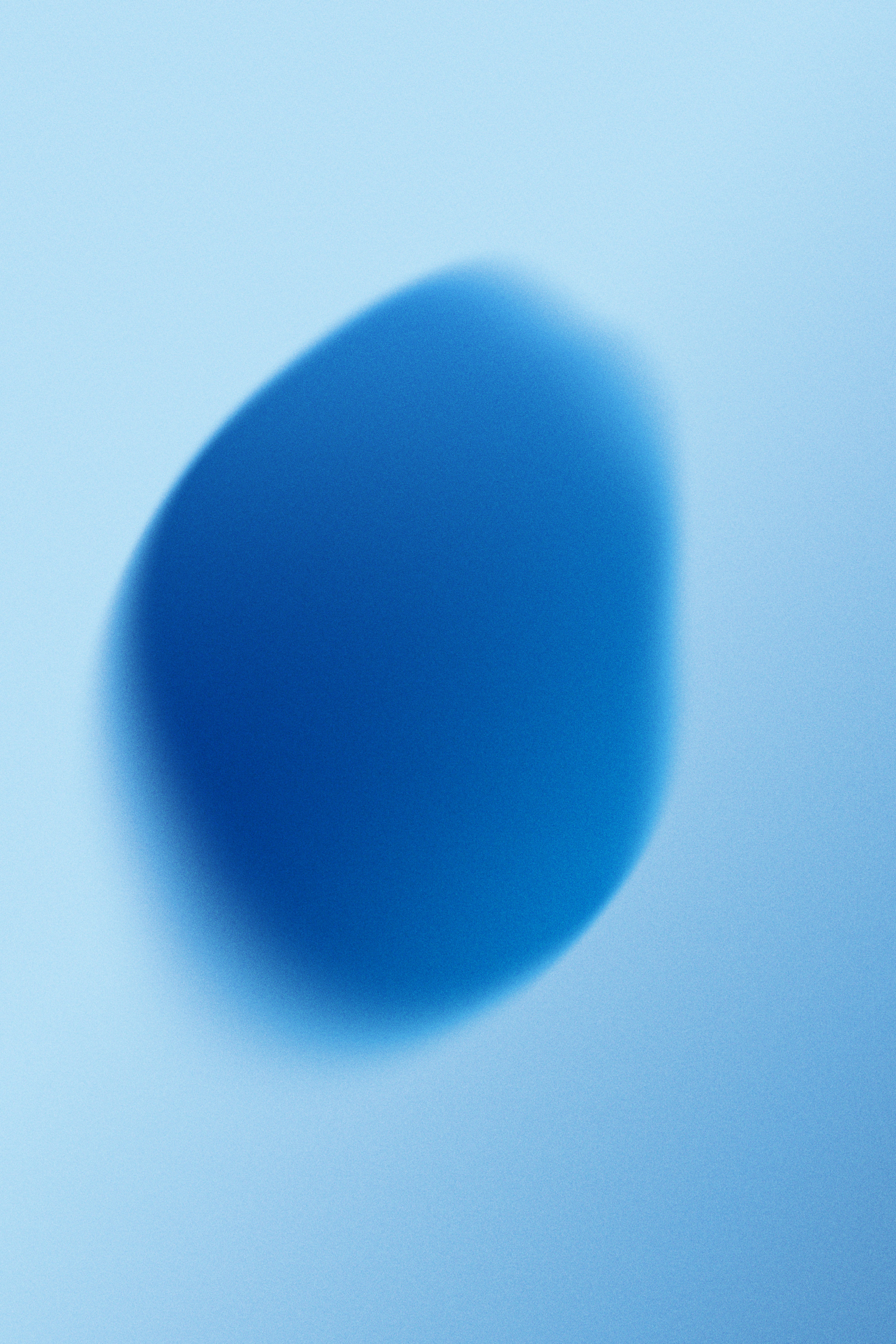 A soft blue gradient with a blurred dark blue oval.