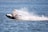 Person riding a jet ski creating a water splash.