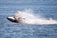 Person riding a jet ski creating a water splash.